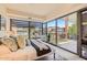 Sunlit main bedroom with floor to ceiling windows and an outdoor terrace with neighborhood views at 7151 E Rancho Vista Dr # 6002, Scottsdale, AZ 85251