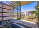 Private terrace with a view of modern, multi-story condominiums, plants, and metal safety railing at 7151 E Rancho Vista Dr # 6002, Scottsdale, AZ 85251