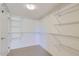 Spacious walk-in closet with neutral colored carpet and adjustable white metal shelving at 7151 E Rancho Vista Dr # 6002, Scottsdale, AZ 85251