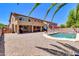 Backyard featuring pool, gravel, outdoor furniture and view of the house under a bright sky at 742 E Kingbird Dr, Gilbert, AZ 85297