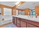 Bathroom featuring a double sink vanity, a large mirror and tile flooring at 742 E Kingbird Dr, Gilbert, AZ 85297