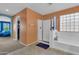 Bright bathroom featuring a shower, a tub, orange walls, and a glass block window at 742 E Kingbird Dr, Gilbert, AZ 85297