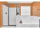 Bright bathroom featuring a shower, a tub, orange walls, and a glass block window at 742 E Kingbird Dr, Gilbert, AZ 85297