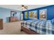 Primary bedroom featuring a ceiling fan, a wooden bed, a carpet floor and blue walls at 742 E Kingbird Dr, Gilbert, AZ 85297