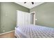 Bedroom showcasing a closet, olive green walls, and neutral-toned carpet at 742 E Kingbird Dr, Gilbert, AZ 85297