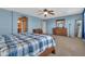 Primary bedroom featuring a ceiling fan, a wooden bed, a carpet floor and blue walls at 742 E Kingbird Dr, Gilbert, AZ 85297