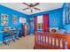 This is a bedroom with blue walls, a ceiling fan, a dark dresser and a window with curtains at 742 E Kingbird Dr, Gilbert, AZ 85297