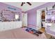 A lavender bedroom with a bed, dresser and a glimpse into a closet space at 742 E Kingbird Dr, Gilbert, AZ 85297