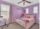 A bedroom with pink walls, a ceiling fan, a bed with pink sheets and a window at 742 E Kingbird Dr, Gilbert, AZ 85297