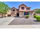 Charming two-story home with a spacious driveway, beautiful landscaping, and a welcoming facade at 742 E Kingbird Dr, Gilbert, AZ 85297