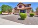 Two-story home featuring a large driveway, desert landscaping, and a well-maintained front yard at 742 E Kingbird Dr, Gilbert, AZ 85297