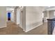 Hallway with carpet floors featuring doorways and neutral colored walls at 742 E Kingbird Dr, Gilbert, AZ 85297