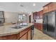 Kitchen with a granite island, stainless steel appliances, and tile flooring at 742 E Kingbird Dr, Gilbert, AZ 85297