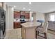 Kitchen island with bar seating, granite countertops, and stainless steel appliances at 742 E Kingbird Dr, Gilbert, AZ 85297