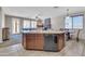Kitchen with tile flooring, a large island with sink, and an open view to the living room at 742 E Kingbird Dr, Gilbert, AZ 85297