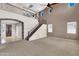 Open concept living room with high ceilings, staircase with iron railing, and large windows at 742 E Kingbird Dr, Gilbert, AZ 85297