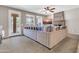 Bright living room boasts a stone fireplace, ceiling fan, and an extra-large sectional sofa at 742 E Kingbird Dr, Gilbert, AZ 85297