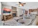 Living room with stone fireplace, flat screen TV and overstuffed sectional sofa at 742 E Kingbird Dr, Gilbert, AZ 85297
