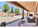 Relaxing covered patio with views of the backyard, pool, and desert landscaping at 742 E Kingbird Dr, Gilbert, AZ 85297