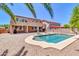 Backyard pool area of this home featuring an in-ground pool, lounge chairs, and desert landscaping at 742 E Kingbird Dr, Gilbert, AZ 85297