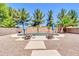 A tranquil pool with desert landscaping and seating, perfect for enjoying the backyard oasis at 742 E Kingbird Dr, Gilbert, AZ 85297