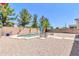 The property offers a sparkling pool with desert landscaping and charming patio umbrellas at 742 E Kingbird Dr, Gilbert, AZ 85297