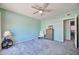 Spacious bedroom featuring carpeted flooring, a ceiling fan, and comfortable chair at 750 E Northern Ave # 2088, Phoenix, AZ 85020