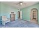 Relaxing bedroom boasts an arched doorway, neutral carpet, ceiling fan and calming color scheme at 750 E Northern Ave # 2088, Phoenix, AZ 85020