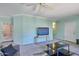 Inviting living room with a ceiling fan, television and glass top coffee table provides a relaxing space at 750 E Northern Ave # 2088, Phoenix, AZ 85020