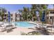 Community pool featuring lounge chairs, tables with umbrellas, and clear, inviting water at 750 E Northern Ave # 2088, Phoenix, AZ 85020