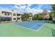 Exterior view of a community tennis court surrounded by lush trees and complex buildings at 750 E Northern Ave # 2088, Phoenix, AZ 85020