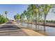 Exterior view of walking path, canal, tall trees, and blue sky at 750 E Northern Ave # 2088, Phoenix, AZ 85020