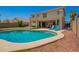 A pristine backyard pool with lounge chairs and a two-story home in the background at 7923 W Hess Ave, Phoenix, AZ 85043