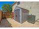 A backyard featuring a storage shed, an AC unit and a fenced patio area at 7923 W Hess Ave, Phoenix, AZ 85043