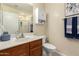 Bright bathroom featuring wood vanity, white countertops, and shower with a glass door at 7923 W Hess Ave, Phoenix, AZ 85043