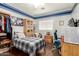 Cozy bedroom with wooden dresser and floors, a large bed, an open closet, and a sunny window for natural light at 7923 W Hess Ave, Phoenix, AZ 85043