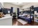 room with a bunk bed, a desk, and wood flooring at 7923 W Hess Ave, Phoenix, AZ 85043