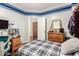 Comfortable bedroom featuring wood floors, a closet, a wooden dresser, and lots of light from a window at 7923 W Hess Ave, Phoenix, AZ 85043