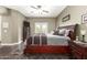Well-lit primary bedroom with a ceiling fan, dresser, and framed pictures at 7923 W Hess Ave, Phoenix, AZ 85043