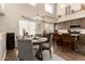 Dining area with large windows and modern fixtures that adjoins an open-concept kitchen with a large island at 7923 W Hess Ave, Phoenix, AZ 85043