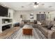 Spacious living room with sectional sofa, area rug, wooden floors, ceiling fan, and large windows for natural light at 7923 W Hess Ave, Phoenix, AZ 85043