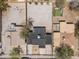 Aerial view of a home's roof surrounded by gravel, grass and neighborhood houses and mature trees at 826 S Drew St, Mesa, AZ 85210