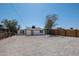 View of the home and backyard with low maintenance desert landscape and a wood fence at 826 S Drew St, Mesa, AZ 85210
