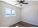 This bedroom features wood-look flooring, neutral walls, and a window providing natural light at 826 S Drew St, Mesa, AZ 85210