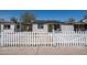 View of this single Gathering house with a white picket fence and green front door at 826 S Drew St, Mesa, AZ 85210