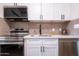 Kitchen featuring stainless steel appliances, white countertops, and neutral backsplash at 826 S Drew St, Mesa, AZ 85210