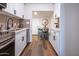 This light and bright kitchen features white cabinets, hardwood floors, and a stainless steel sink at 826 S Drew St, Mesa, AZ 85210