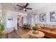 Spacious living room featuring a ceiling fan, modern decor, and sleek hardwood flooring at 826 S Drew St, Mesa, AZ 85210