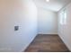 A simple room featuring wood-look flooring, white walls, and a window for natural light at 826 S Drew St, Mesa, AZ 85210