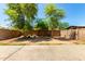 A private backyard with mature trees providing plenty of shade at 8341 W Cypress St, Phoenix, AZ 85037